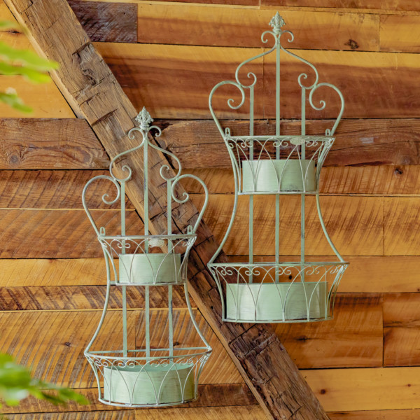 Two dual green hanging iron basket planters with curlicue designs