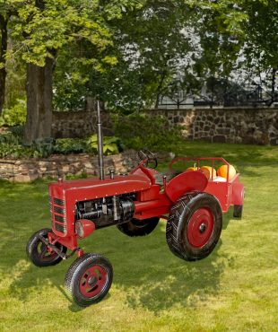 12.5 foot long large red metal tractor with pumpkins in cart in garden