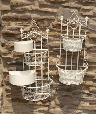 Set of 2 dual half moon-shaped wall hanging planter with removable baskets in antique white distressed finish on a brick wall