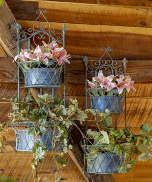 One set of blue hanging wall planters with removeable baskets and has curlicue designs on the top and in the two places where the removable baskets goes