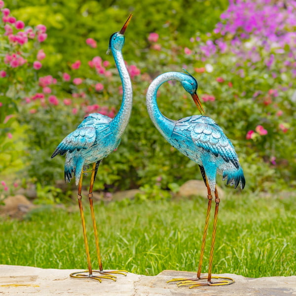 Set of two metallic blue iron garden figurines with one looking upright wile the other is looking to the back of him