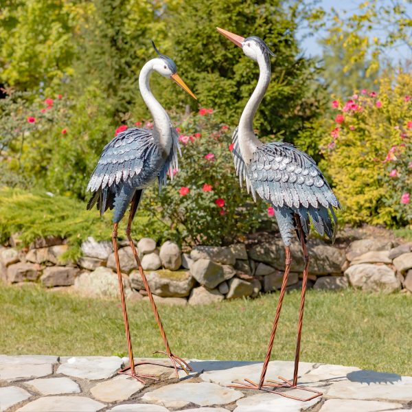 2 metal blue heron garden figurines 46 inches tall standing in beautiful garden