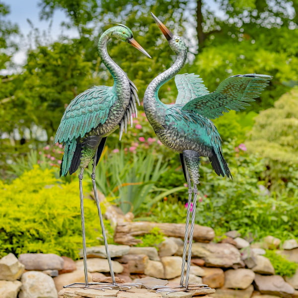 A Pair of Metal Herons One Head up one Head Down with Wings Back