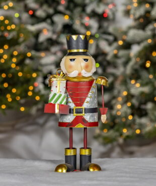Galvanized metal classic Christmas nutcracker figurine holding Christmas gifts