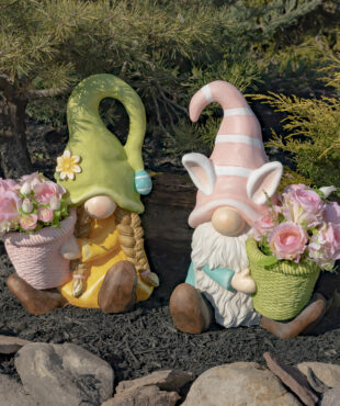 One set of two Easter gnomes one male and one female both sitting holding a planter with pink flowers in it (Flowers not included)