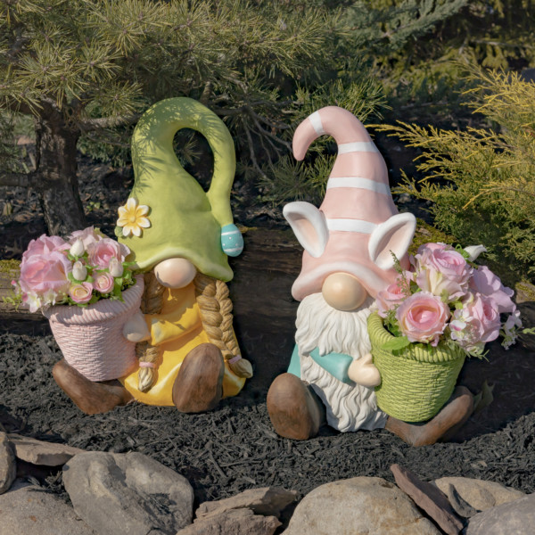 One set of two Easter gnomes one male and one female both sitting holding a planter with pink flowers in it (Flowers not included)