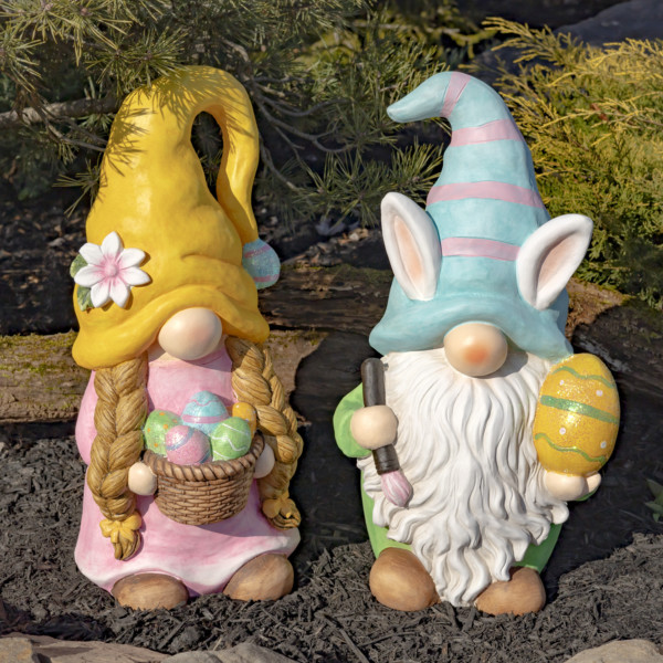 One set of Easter Gnomes in pastel colors with the male gnome holding a large yellow Easter egg and the female gnome holding a basket of colorful Easter eggs