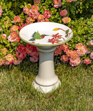 15 tall round porcelain pedestal birdbath in white with Hummingbird and Flowers Walela in front of rose bush