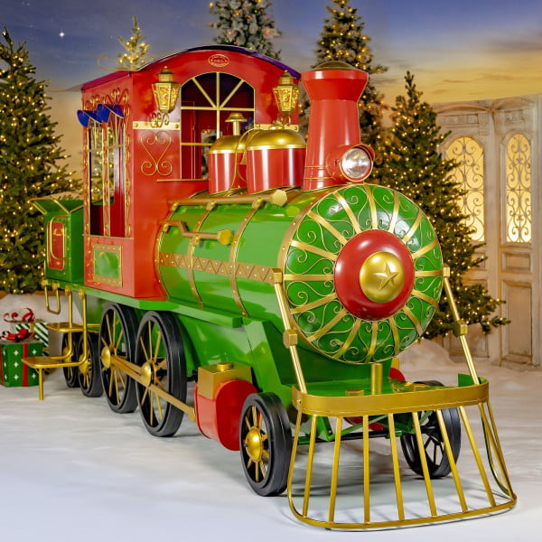 Front view on extra large 16 feet long iron Christmas metal train in glossy red, green and gold
