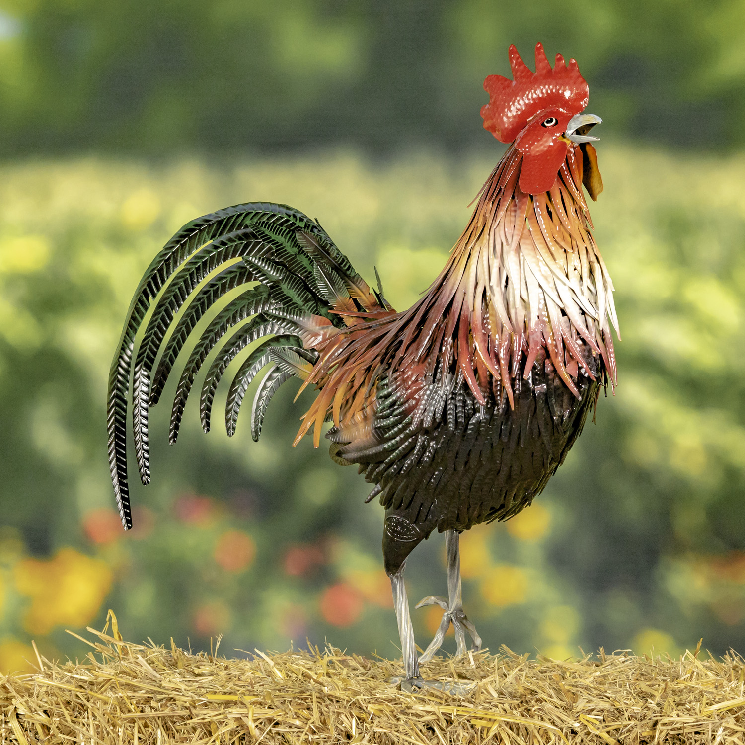 Tall painted Iron Rooster figurine with red comb on his head with orange,yellow and white feathers running down his back and dark green sickle feathers behind him standing on one feet with the other feet slightly off the ground