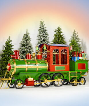 12.5 feet long large iron Christmas train with cart and lanterns in red, green and gold the north pole express in front of Christmas trees towers and sunrise gradient