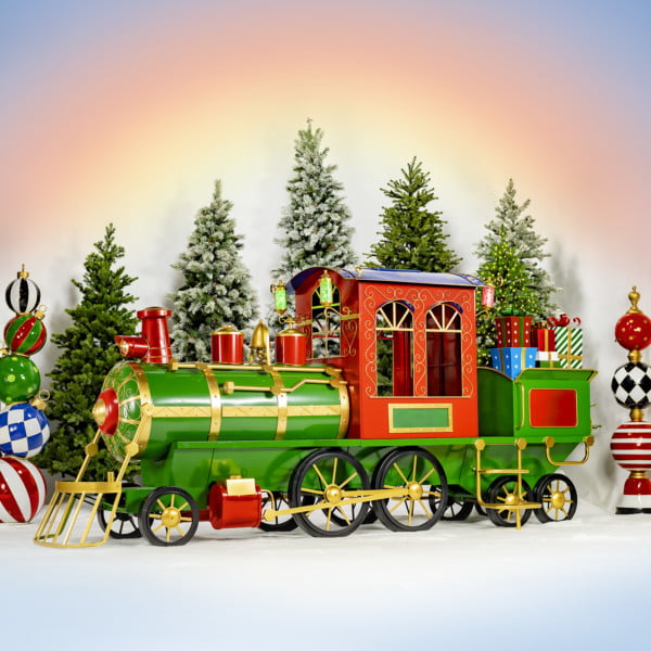 12.5 feet long large iron Christmas train with cart and lanterns in red, green and gold the north pole express in front of Christmas trees towers and sunrise gradient