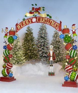 Large iron Christmas Archway with Santa's Elves, ball ornaments, swooping ribbon-like banner with Merry Christmas lettering