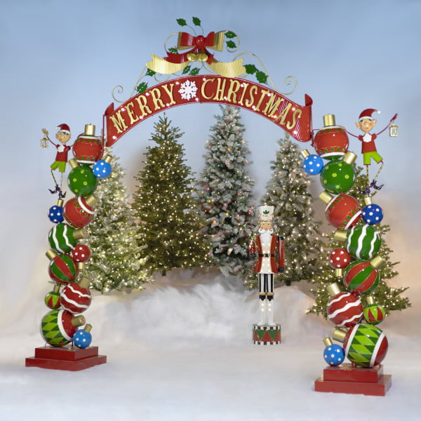 Large iron Christmas Archway with Santa's Elves, ball ornaments, swooping ribbon-like banner with Merry Christmas lettering