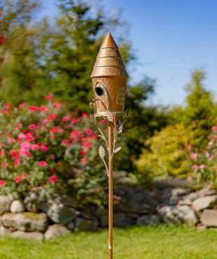Iron birdhouse with cone roof in antique copper finish with patina details