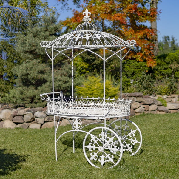 iron flower cart with two wheels and canopy roof decorated with fleur-de-lis details hand-painted in antique white distressed finish