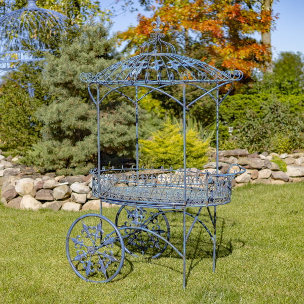 iron flower cart with two wheels and canopy roof decorated with fleur-de-lis details hand-painted in antique blue distressed finish