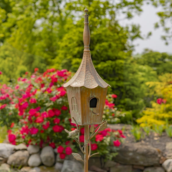 closed up image of iron birdhouse stake in antique copper hand-painted distressed finish with patina details with cone roof and little bird perched on decorative leaf