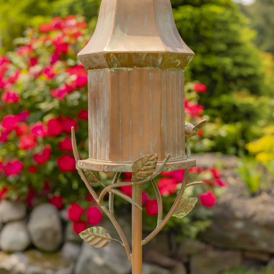 closed up image of rear view of iron birdhouse stake in antique copper hand-painted distressed finish with patina details with bell roof and little bird perched on decorative leaf