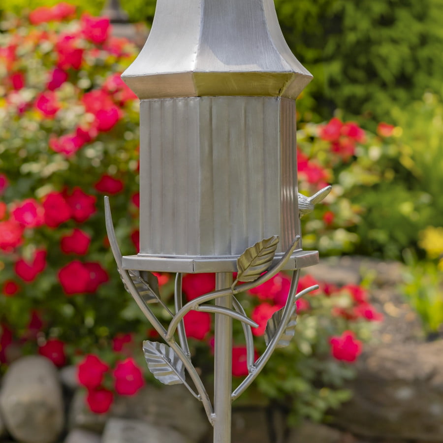 closed up image of rear view of iron birdhouse stake in antique silver hand-painted finish with bell roof and little bird perched on decorative leaf