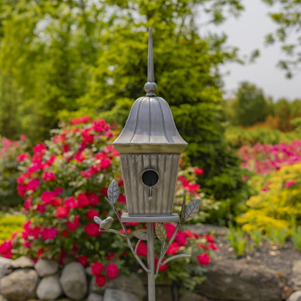 front view of iron cone roof birdhouse stake in antique silver hand-painted finish with little bird perched on decorative leaf