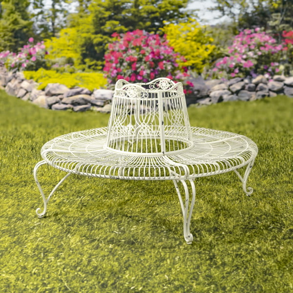 Victorian style round metal tree bench in distressed antique white finish in beautiful garden