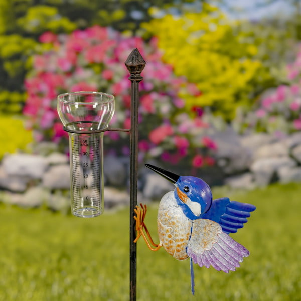 closed up image garden stake with hummingbird and glass rain gauge