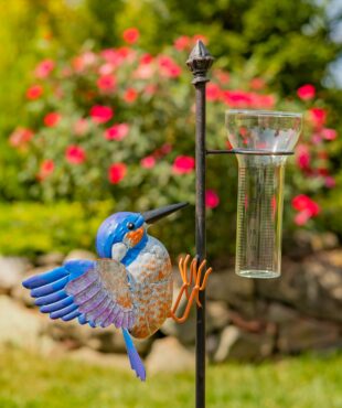 closed up image garden stake with hummingbird and glass rain gauge