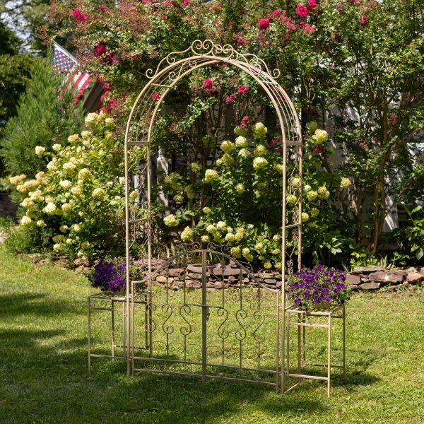 Iron Garden gate archway with 2 side Plant Stands with flowers on them in distressed antique white finish in garden