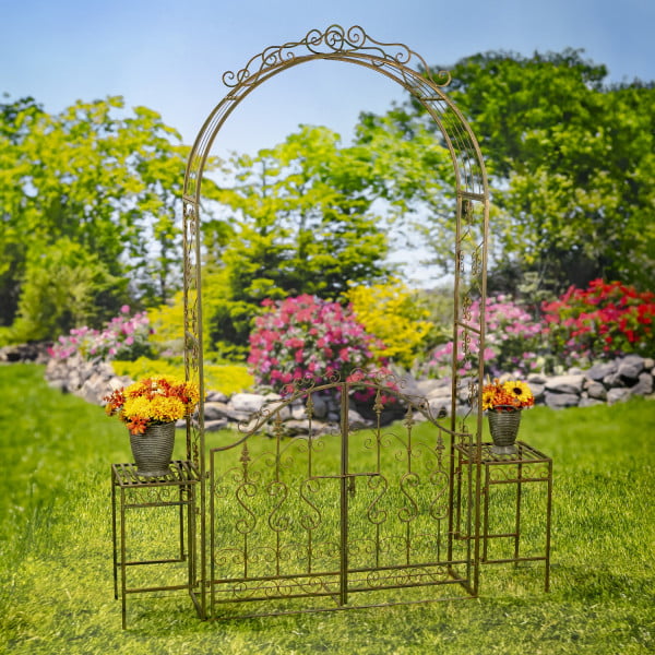 Iron Garden gate archway with 2 side Plant Stands with flowers on them in distressed antique bronze finish in garden