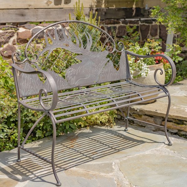 classic iron garden bench round top backrest has a lattice patter with a large Caribou head and mountain details engraved with a texture in distressed antique bronze finish