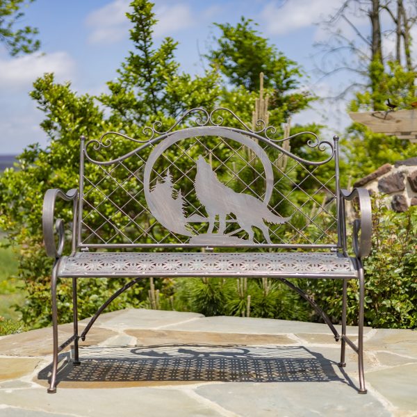 classic iron garden bench with ornate round top with engraved howling wolf and moon in distressed antique bronze finish