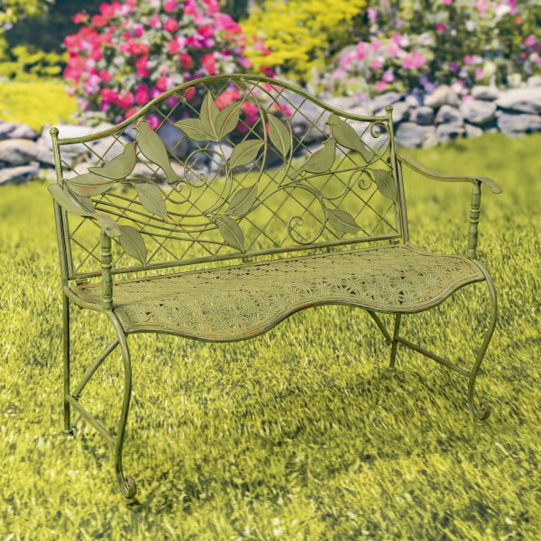 Classic iron garden bench with lattice backrest and engraved perched birds on leaves in antique green distressed finish