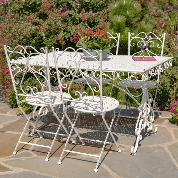 Metal dining set for 4 people consists of 4 chairs and 1 rectangular table in destressed antique white finish decorated with 2 clear vases with flowers