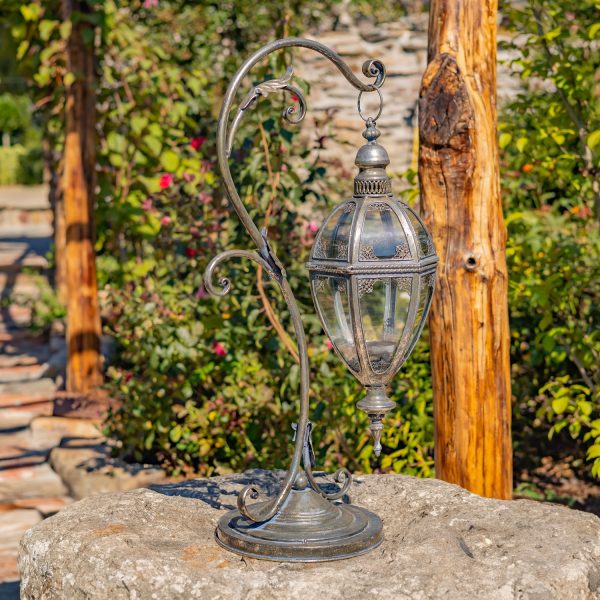 31 Tall Victorian-Style Hanging Lantern with Ornate Iron Stand in silver finish standing in garden