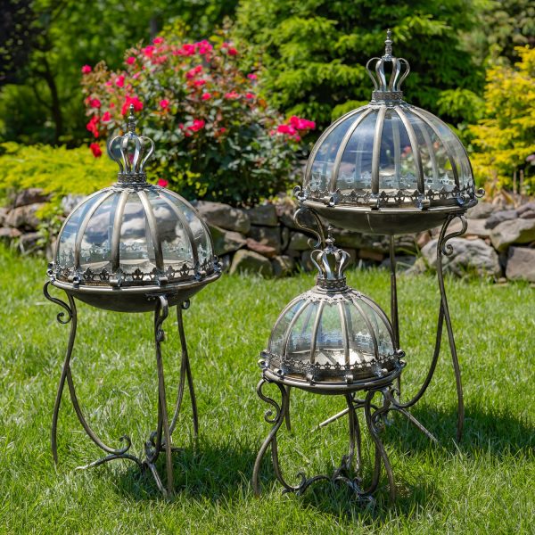 Set of 3 glass dome terrariums in 3 sized hand painted in frosted silver finish standing in garden