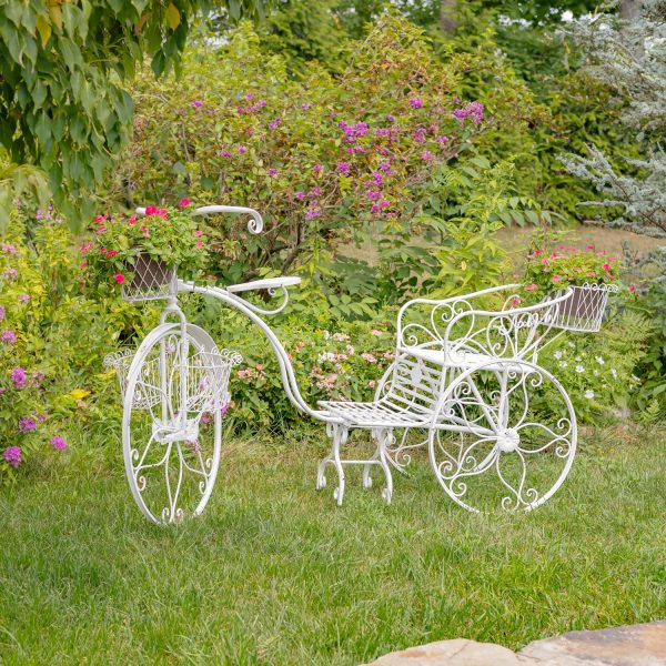 Large iron tricycle plant stand with flower baskets in antique white in garden