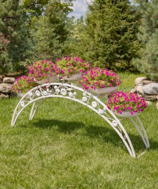 6.6 feet long bridge-like plant stand with 5 round planters and flower pots on them