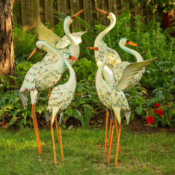 Set of 6 great white heron metal figurines in distressed finish standing in garden