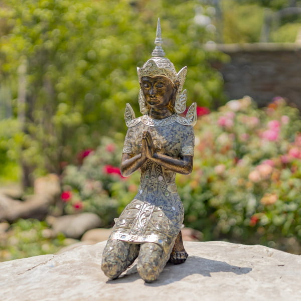 Thai Buddha kneeling in Prayer Statue in garden