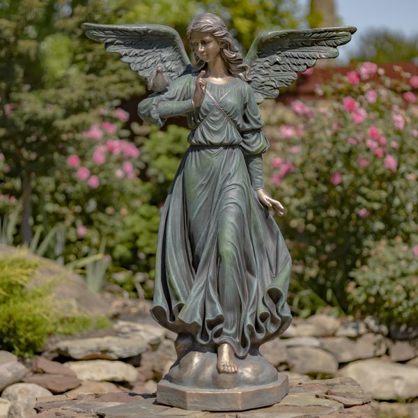 image of 46 inch tall angel statue with open wings in billowing dress and bird perched on her shoulder, painted in antique bronze finish, standing in garden