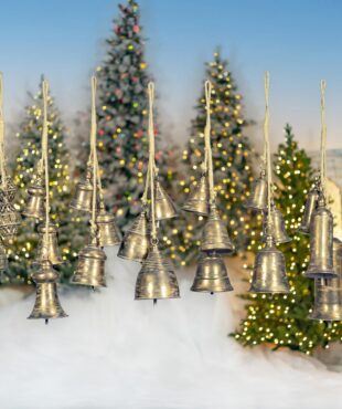 set of 7 iron cluster bells in gold finish hanging on rope in front of Christmas trees
