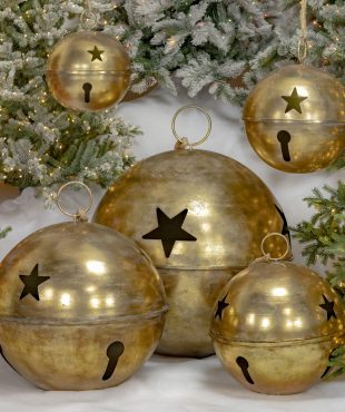 Set of 5 large sleigh bells with star cutouts in antique gold finish, 3 standing on faux snow and 2 hanging on rope