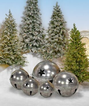 Set of 5 large sleigh bells with star cutouts in antique silver finish, 3 standing on faux snow and 2 hanging on rope