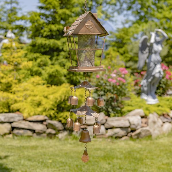 37 inch long iron birdfeeder in cottage shape with toadstool and bell accents attached underneath it in antique copper finish