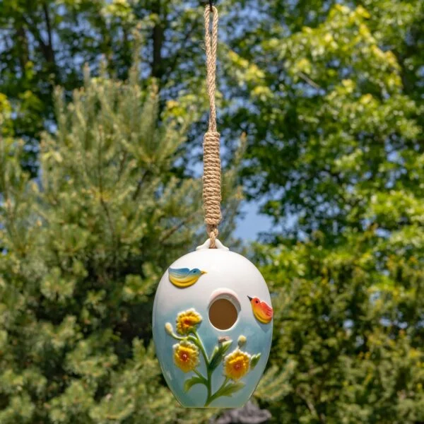 The "Fauna" style features a pastel blue ombré base with hand painted birds and daffodils.