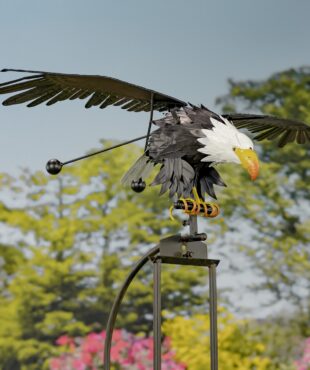 Eagle rocking stake with a sky background with wings open