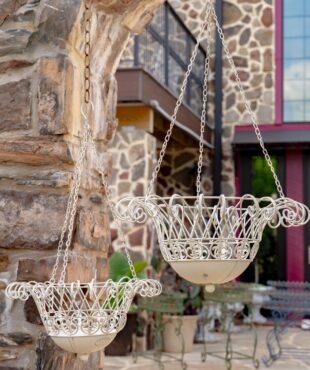 Two hanging planters in antique white with iron detailed style
