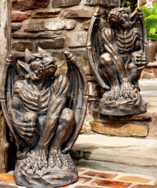 Two gargoyles in antique bronze, showing the front with their arms and legs