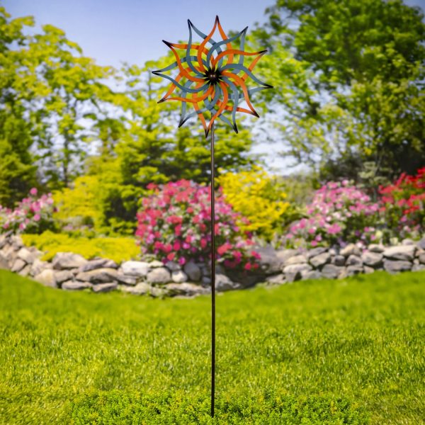 The iron abstract-shaped windmill blades are hand painted in metallic blue and orange jewel tones, adding color
